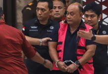 Dadan Hindayana keluar dari Gedung Jampidsus Kejaksaan Agung dengan rompi merah muda